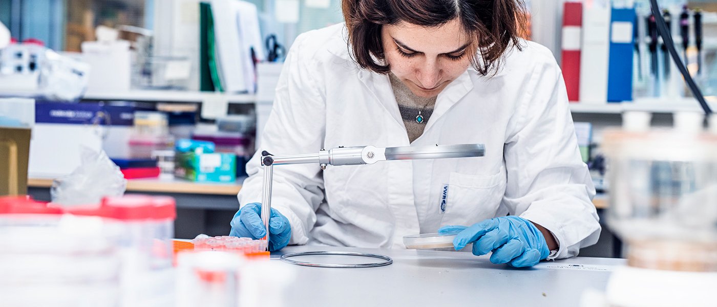 female scientist looking throuh a magnifier