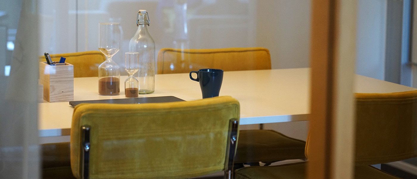 A meeting room with yellow chairs