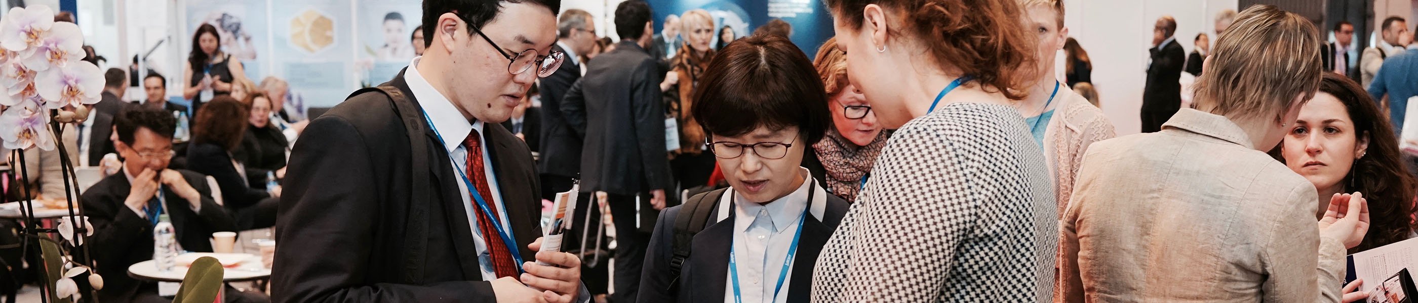 Three persons having a discussion at a exhibition