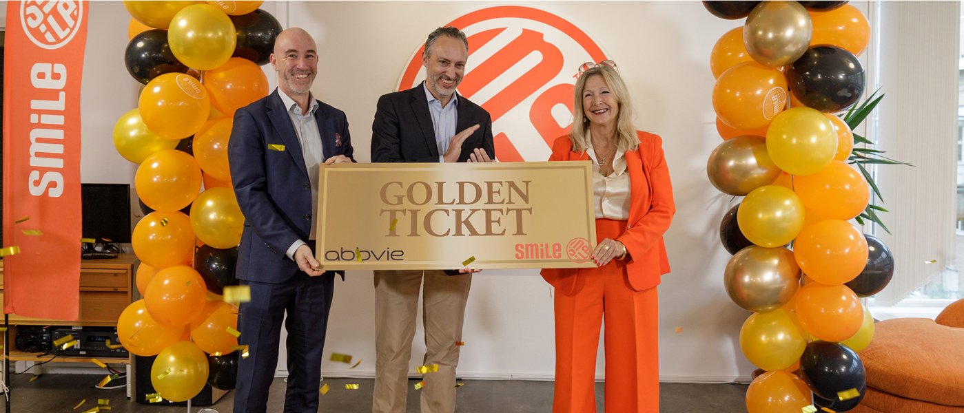 Two men and a woman holding a big golden ticket