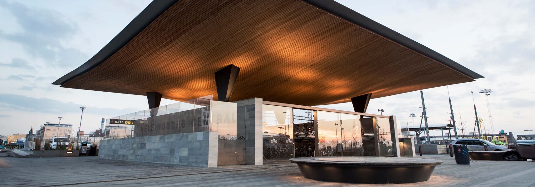 A modern bike parking lot seen from the outside, wood ceiling