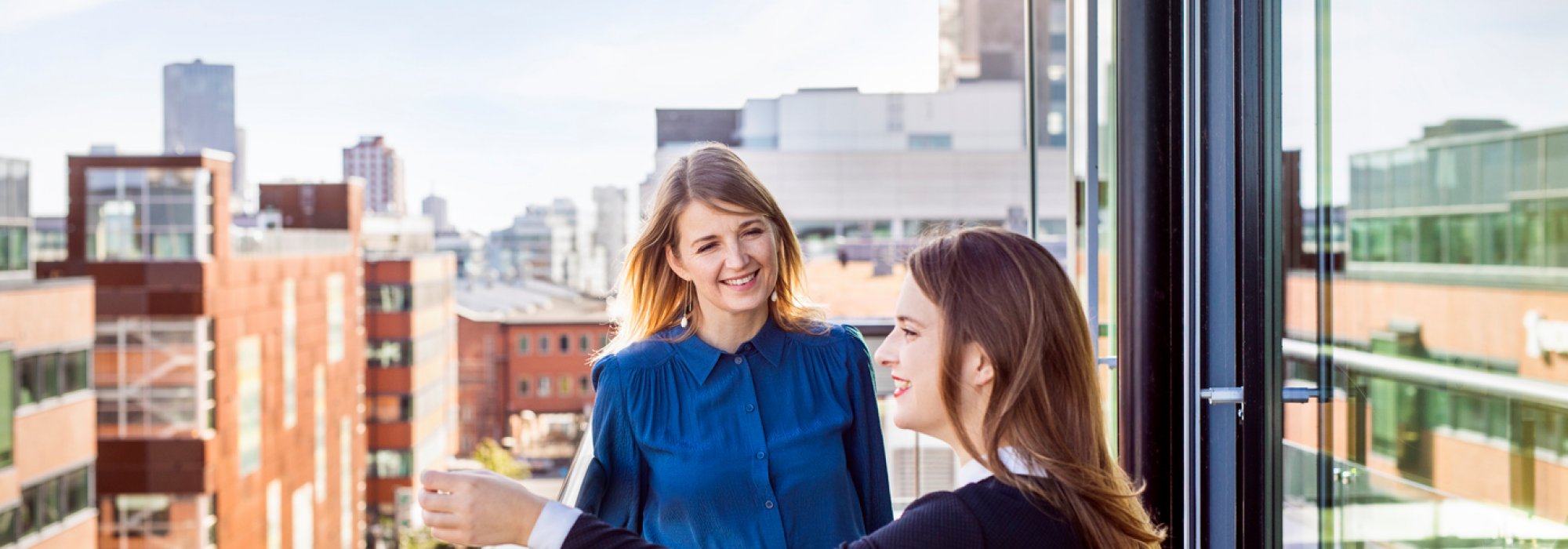 two persons at a balcony