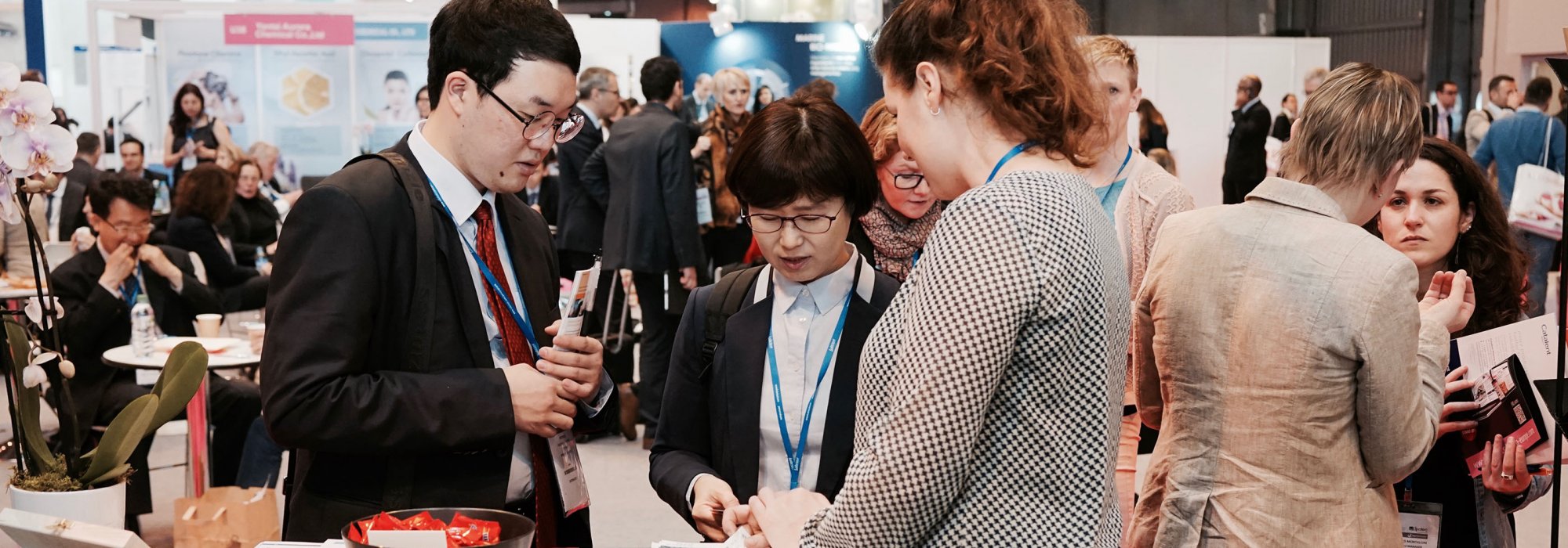 Three persons having a discussion at a exhibition