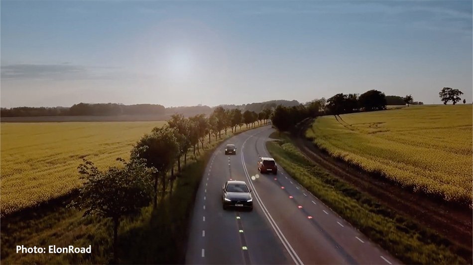 Three cars driving on a road in the sunset