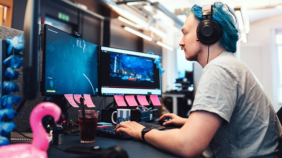 A man developing a computer game in a office environment